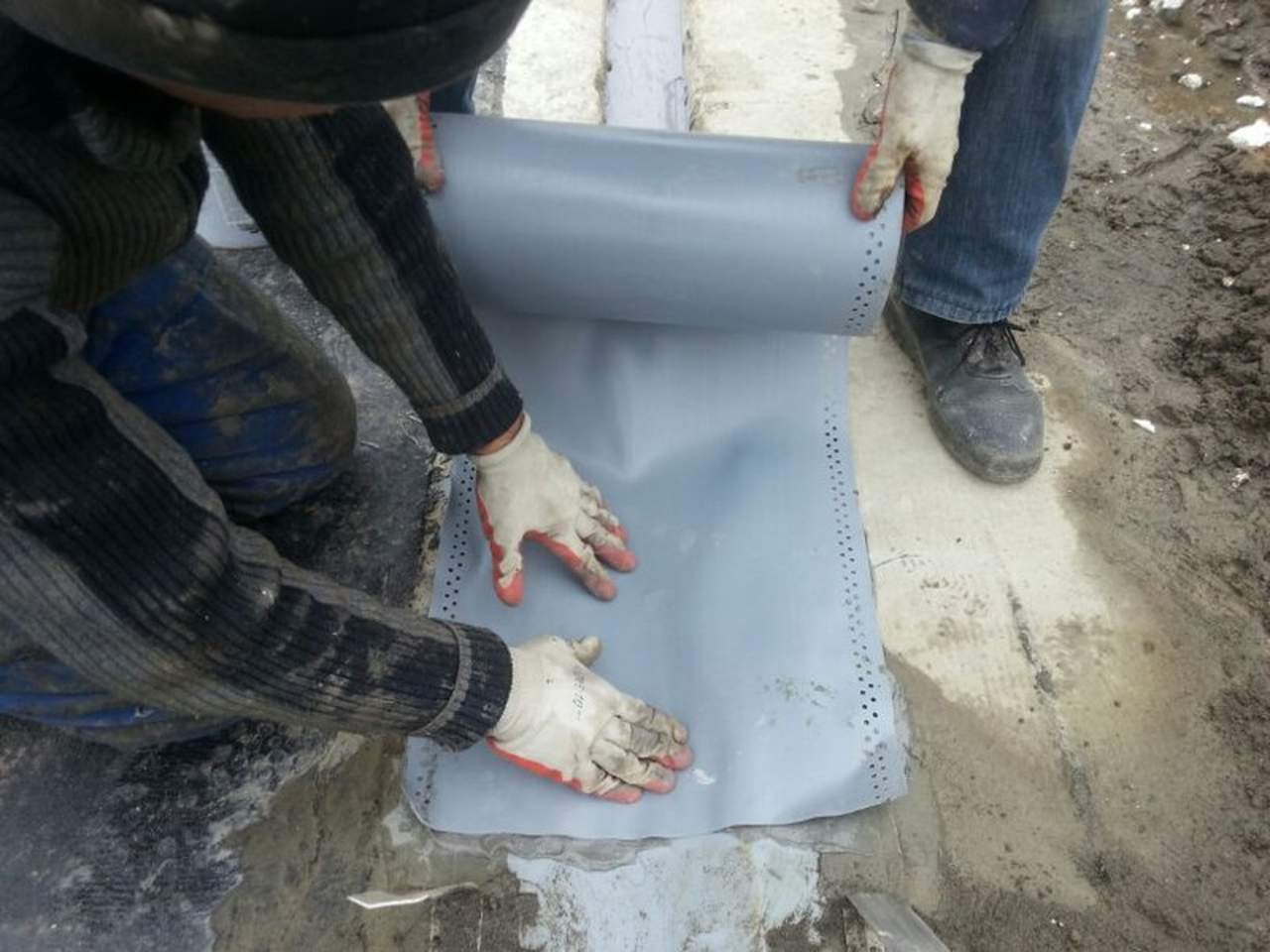 workers applying expansion joint tape