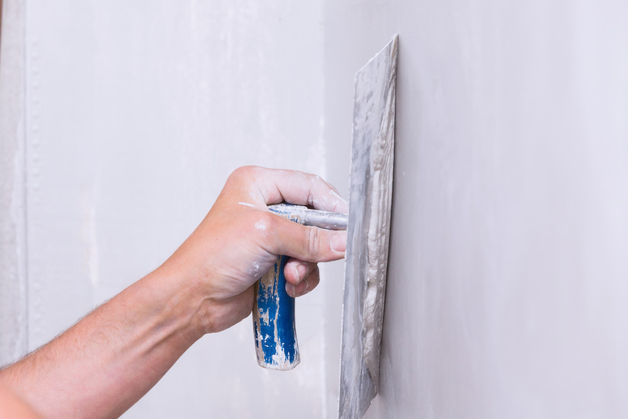 man plastering the wall