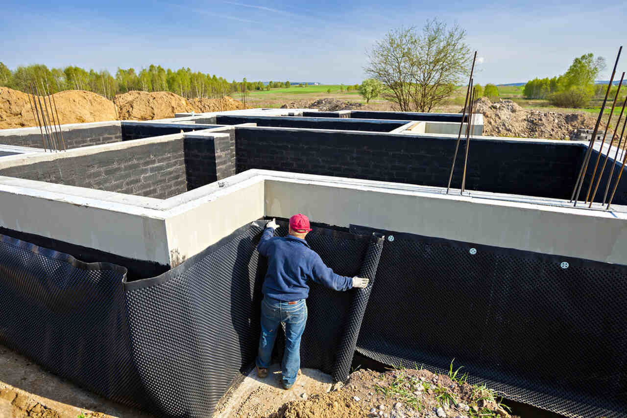 worker applying foundation waterproofing